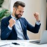 Successful joyful lucky caucasian businessman in a suit, ceo company, manager, sits at work desk in